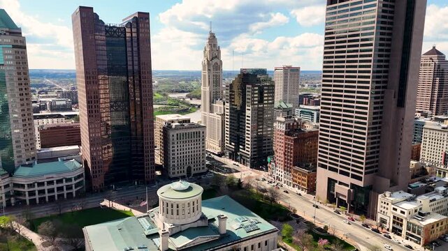 A cinematic drone shot capturing the modern skyline of Columbus, Ohio, USA, showcasing downtown architecture, urban development, office buildings, streets, and the vibrant atmosphere of the state capi