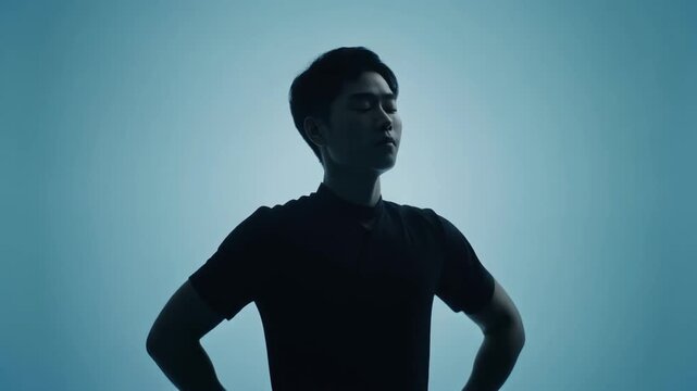 深呼吸をしてリラックスする人物のシルエット