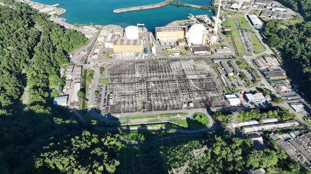 Nuclear energy as an alternative energy source. Operational nuclear power plant. Aerial view. establishing shot.