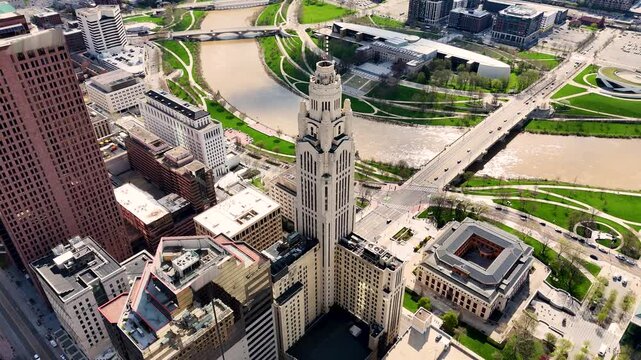 A cinematic drone shot capturing the modern skyline of Columbus, Ohio, USA, showcasing downtown architecture, urban development, office buildings, streets, and the vibrant atmosphere of the state capi