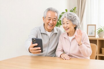 自宅で家族とのビデオ通話を楽しむ日本人シニア夫婦