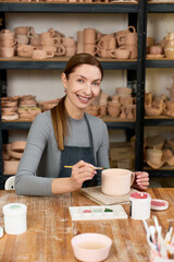 Skilled potter creating unique pieces in a charming ceramic workshop © LIGHTFIELD STUDIOS