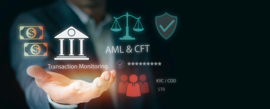 Businessman holding virtual icons for banking compliance. Concepts of anti money laundering (AML), countering financing of terrorism (CFT), transaction monitoring, and financial security network.