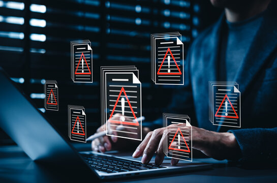 Data breach alert and corrupted file virus error system concept. Person typing on laptop computer to detect malware infection, cyber attack hazard, data privacy vulnerability, document security threat