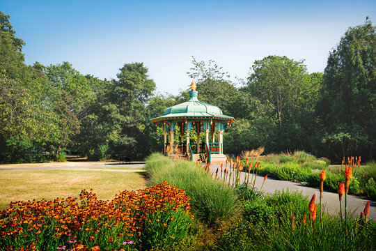 Bandstand flanked by colour flowrs and trees in summer, Hull, UK.