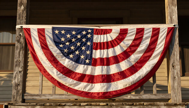Patriotic American bunting flag hanging on a rustic wooden porch during golden hour, capturing a warm nostalgic holiday mood.
