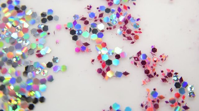 Scattered iridescent hexagonal glitter pieces