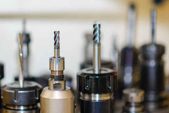 Close-up of a group of used solid carbide flat nose end mill tools for CNC milling machines.