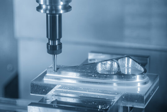 High-precision CNC milling machine performing an aerospace parts production process with a ball nose end mill tool.