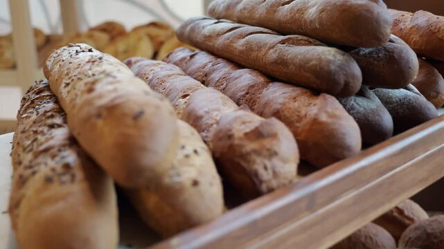 A close-up of a freshly baked baguette on the shelf of a bakery. Delicious bread, the concept of public catering.