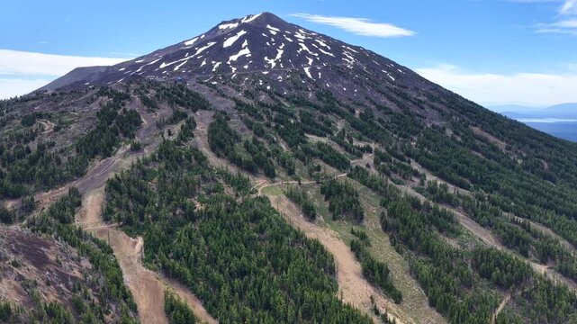 Mt. Bachelor and its many ski trails rise from the Deschutes National Forest in Oregon. This iconic volcanic mountain is part of the Cascade Range and just 22 miles from Bend.