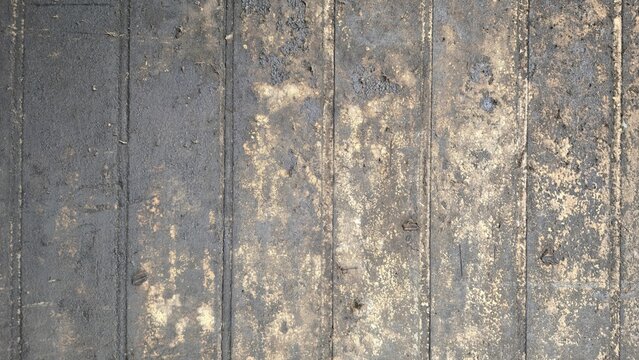 Grungy oil stained wooden surface industrial backdrop. Abstract time-worn distressed wooden boards texture. Textured abstract of damaged dark wooden panel with heavy grime and industrial oil marks.