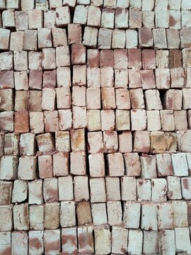 Stacked red bricks ready for construction a textured wall pattern