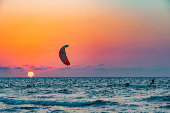 beautiful sunset over the sea and kitesurfer silhouette