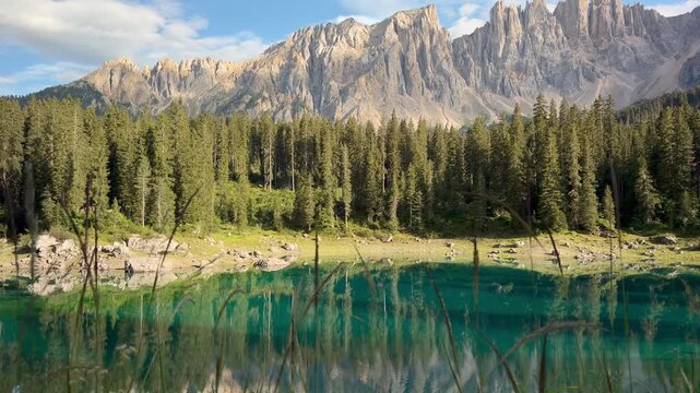 Scenic Turquoise Lake Carezza Reflecting Latemar Mountains and Alpine Forest in the Italian Dolomites
