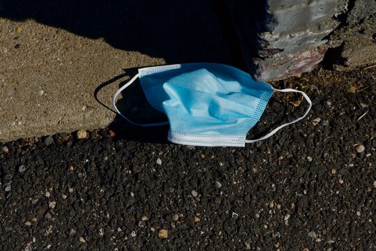 Medical waste a protective mask thrown on the ground