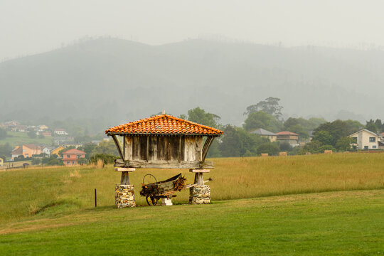 Traditional Asturian Horreo in a Misty Rural Landscape