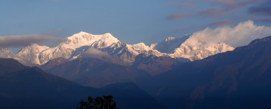 Title
Sunrise over Mount Kanchenjunga Range from Pelling Sikkim India with Snow Capped Himalayan Peaks Golden Morning Light Scenic Mountain Landscape