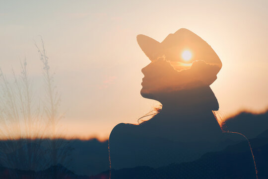 Positive woman enjoys harmony inner peace and awareness in nature experience. Calmness and freedom of mind concept. Vacation and relaxation.