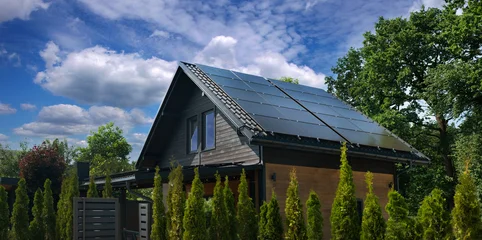 modern eco-friendly house with solar panels on the roof. © pavlobaliukh