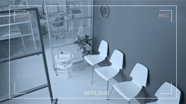 CCTV shot of empty vet clinic lobby being monitored by security camera. Clip is suitable for corporate surveillance, business security, and office safety promotions