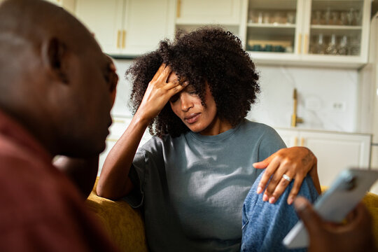 Stressed couple having a difficult conversation in the home kitchen
