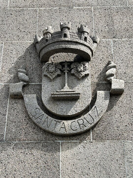 Coat of arms of the city of Santa Cruz on the gray stone wall. Madeira. Portugal.