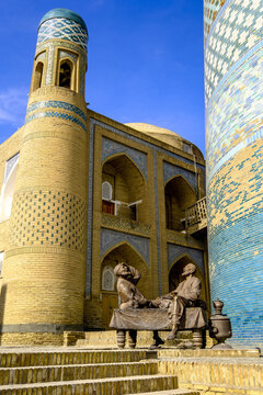Statue showing traditional Uzbek life in Khiva with architectural features and local figures