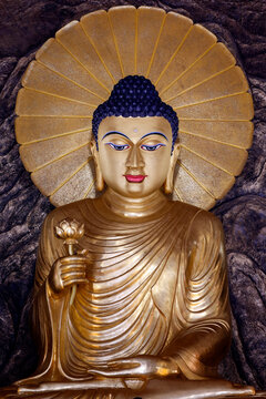 Golden Buddha holding a lotus flower at Truc Lam Chanh Giac Zen Monastery in Cai Lay, Vietnam