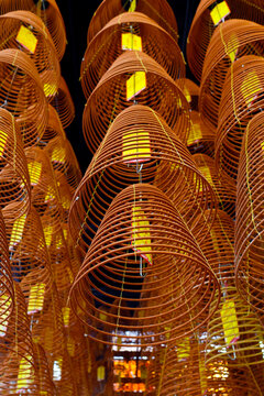 Large incense spirals hang from the ceiling inside Ong pagoda in Can Tho, Vietnam dedicated to Kuang Kung