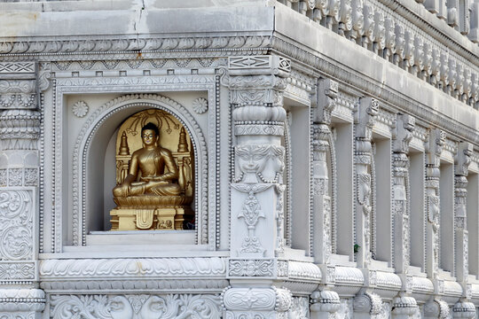 Buddha statue in lotus position at Truc Lam Chanh Giac Zen Monastery in Cai Lay Vietnam surrounded by intricate architecture