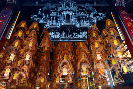 Large incense spirals hanging from the ceiling in Ong pagoda dedicated to Kuang Kung in Can Tho