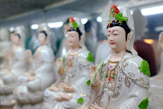 Guan Yin statues in display at a shop in Ho Chi Minh City, Vietnam showcasing the bodhisattva of compassion