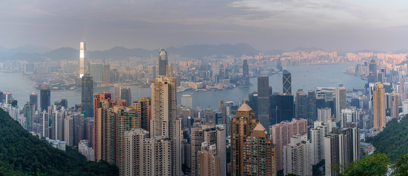 View of Hong Kong and Kowloon Peninsula from Victoria Peak during sunset overlooking the city skyline and harbor