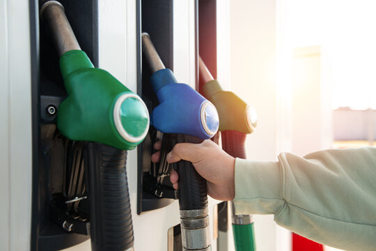 Man holding pump ready to refuel car with gasoline