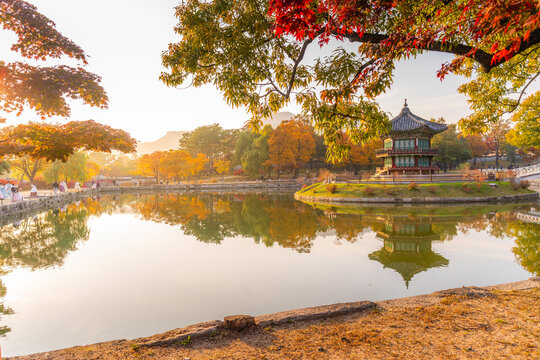 Hyangwonjeong Pavilion and reflections at sunset during autumn in Gyeongbokgung Palace in Seoul, South Korea