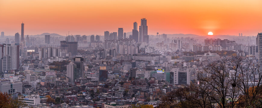 View of Seoul skyline at sunset from N Seoul Tower in autumn season with city buildings and mountains, South Korea