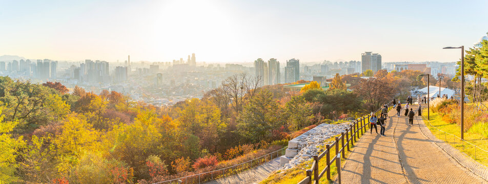 View of Seoul skyline from N Seoul Tower at golden hour in autumn with people walking