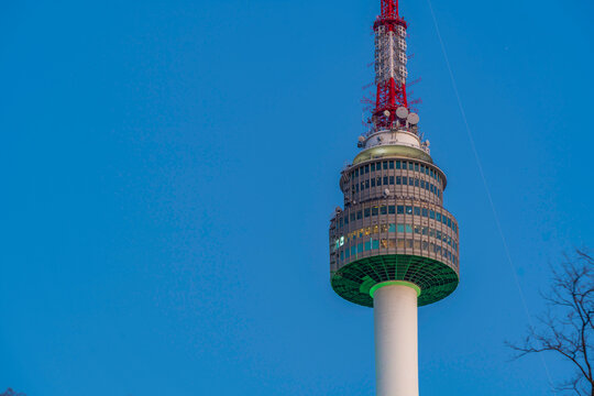 N Seoul Tower stands tall amid autumn trees in Yongsan District of Seoul South Korea during a clear daylight