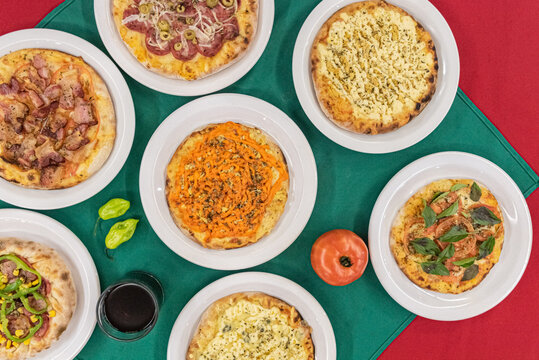 Overhead shot featuring a variety brazilian pizzas