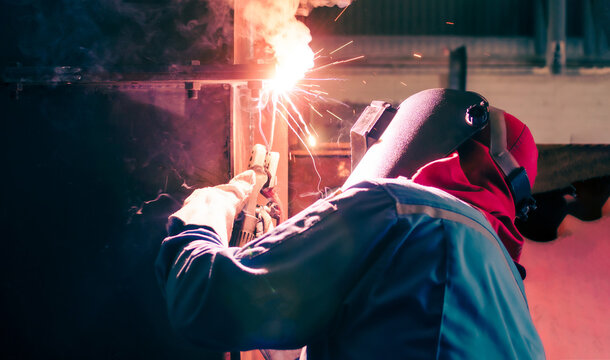 Welding steel structures and bright sparks in construction industry.