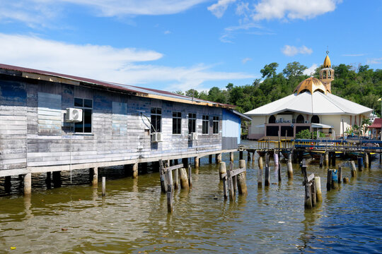 Kampong Ayer water village mosque stands by wooden houses above water in Bandar Seri Begawan