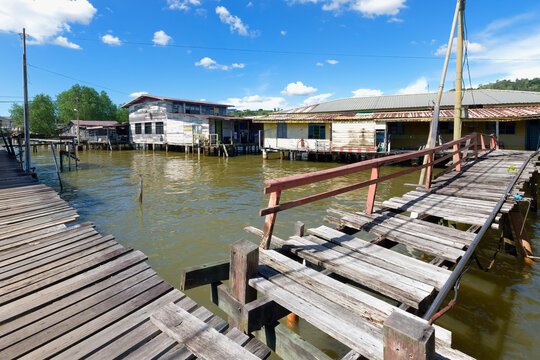 Kampong Ayer water village features walkways and houses built on stilts in Bandar Seri Begawan, Brunei on a sunny day