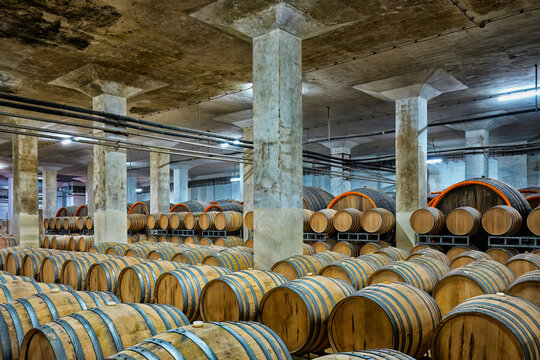 Wine barrels stored in the cellar of Murfatlar winery in Romania, showing the winemaking process and storage method used