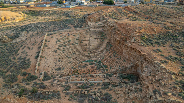 Historic amphitheatre stands in ruins above ancient city site in Eastern Libya, recalling a once vibrant cultural scene