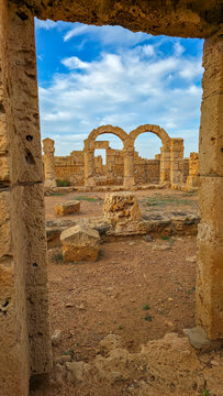Ruins of ancient Apollonia showing stone structures in a dry landscape with blue sky in Eastern Libya