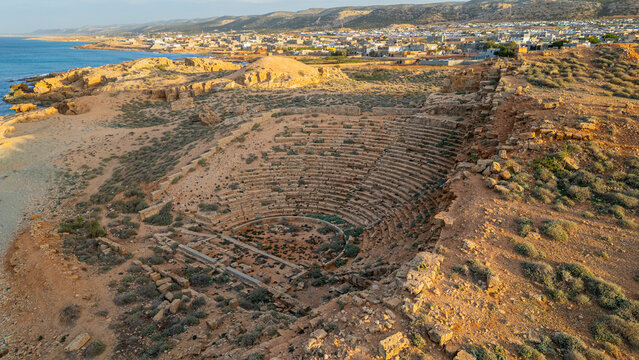 Ruins of amphitheatre in Apollonia showing ancient structures under sunlight near coastline in Libya