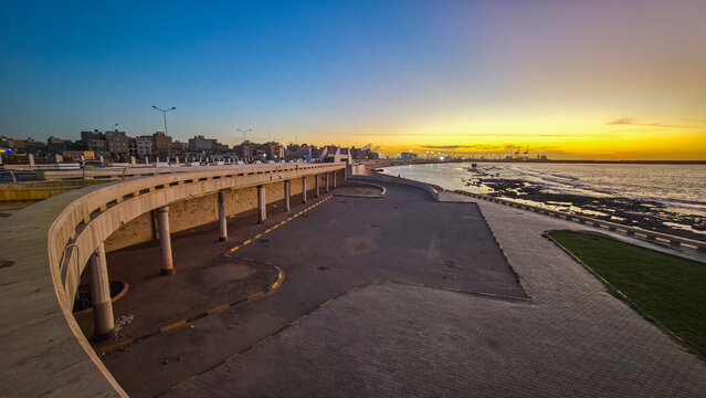 Sunset along the waterfront in Benghazi, Libya with city skyline visible in the background