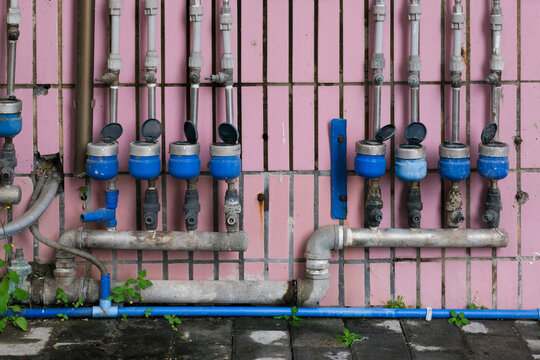 Utility Pipes on Pink Wall