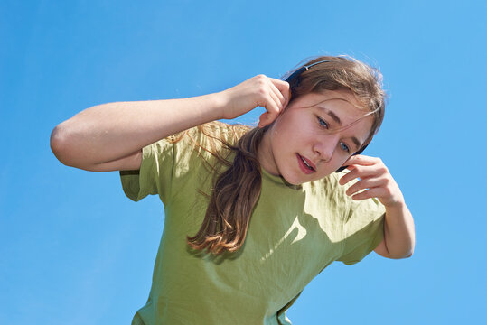 Girl listens to music while enjoying outdoor activity
